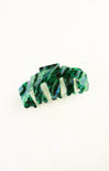 Green and white marbled hair clip on a white background