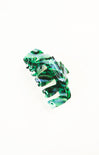 Green and clear hair clip on a white background
