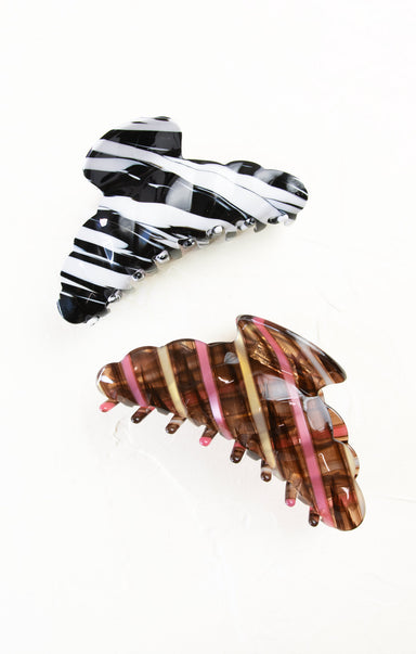 Two hair clips with zebra print design on a white background