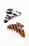 Two hair clips with zebra print design on a white background