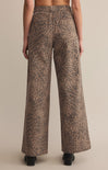 A pair of high-waisted, full-length leopard print denim pants with a zip fly and button closure.
