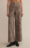 A pair of high-waisted, full-length leopard print denim pants with a zip fly and button closure.