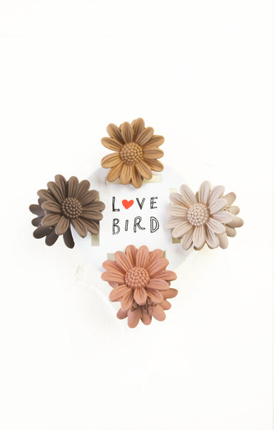 Set of four flower-shaped earrings with 'Love Bird' text on a white background