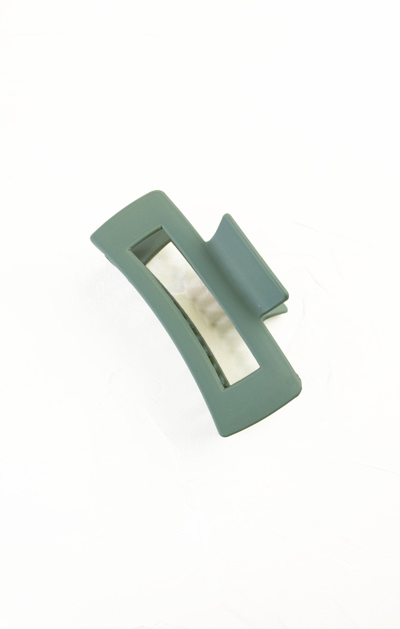 Green hair clip on a white background