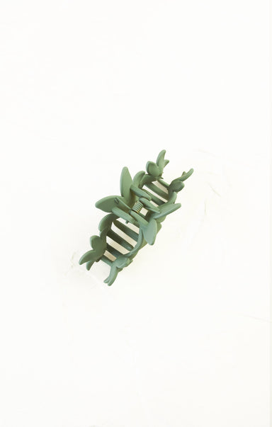 Green plastic toy with a snake-like design on a white background