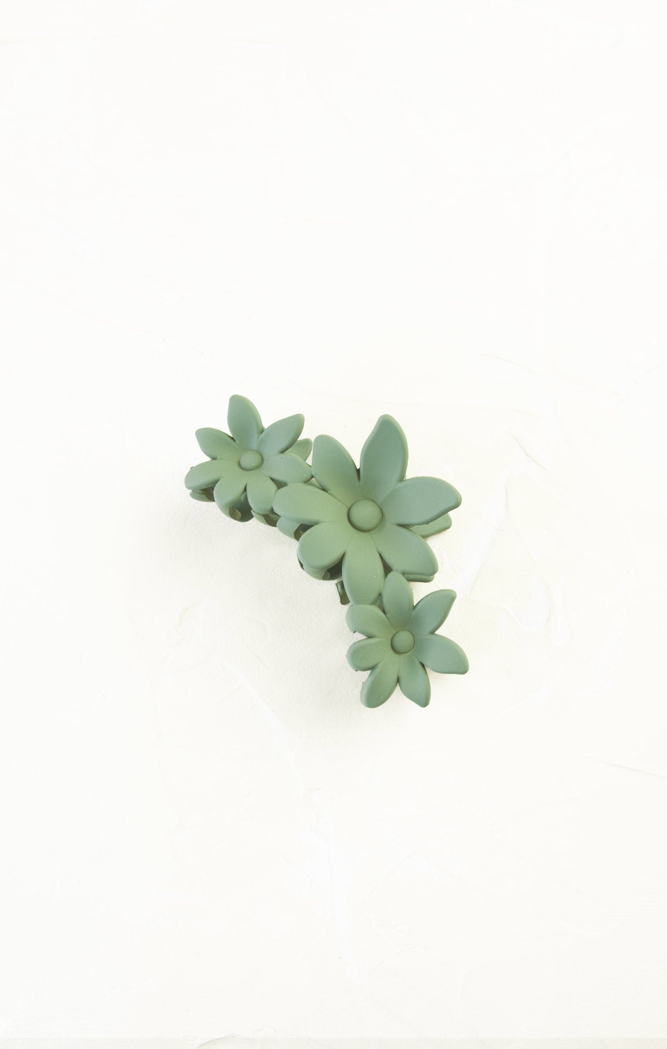 Green floral hair clip on a white background