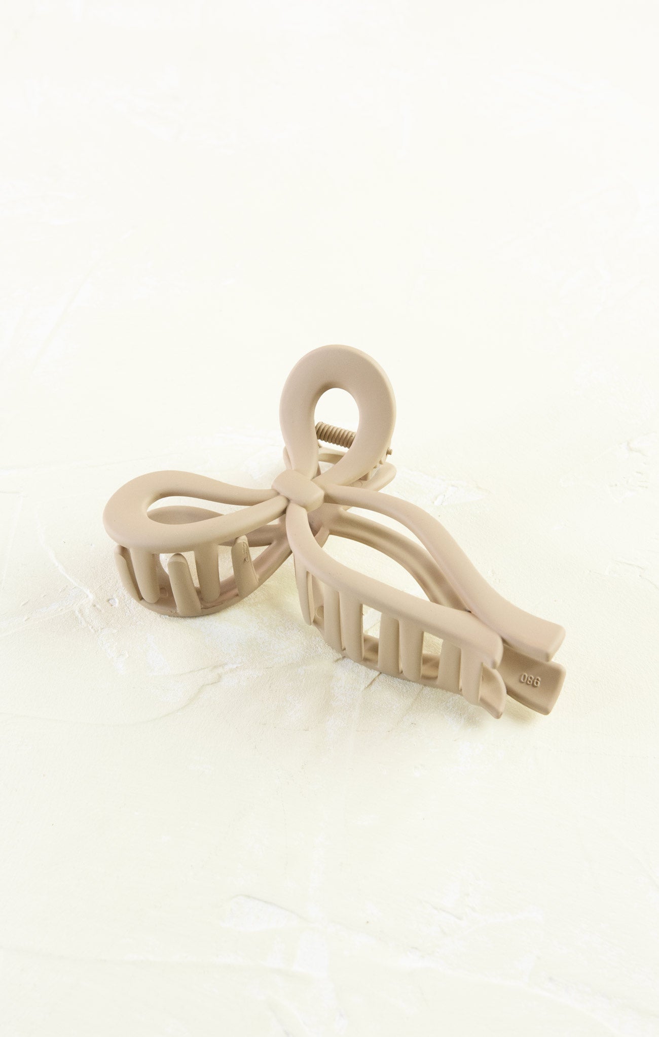 Beige hair clip on a white background