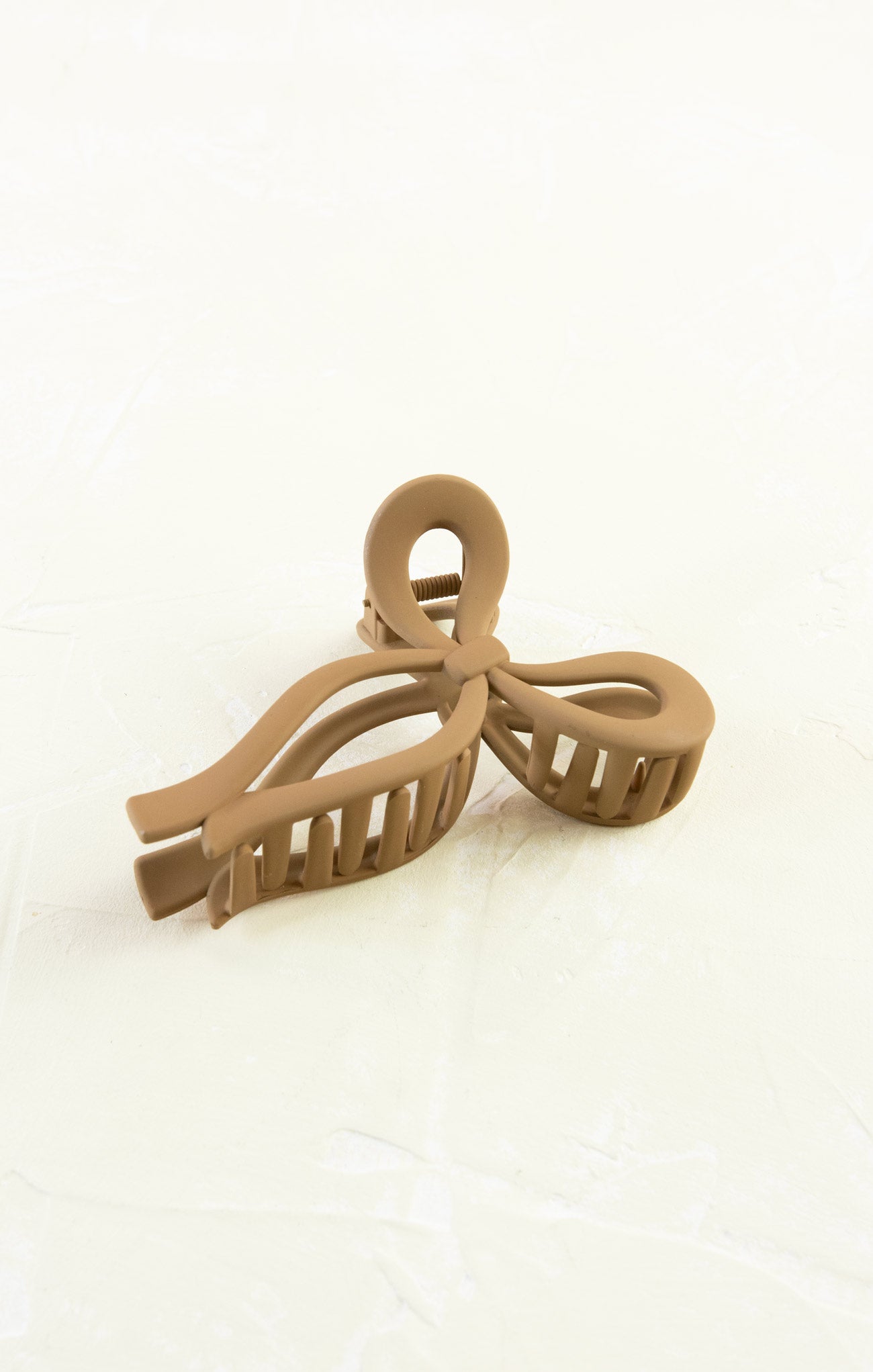 Beige hair clip on a white background