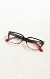 Black and red eyeglasses on a white background