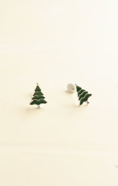 Green Christmas tree earrings on a beige background
