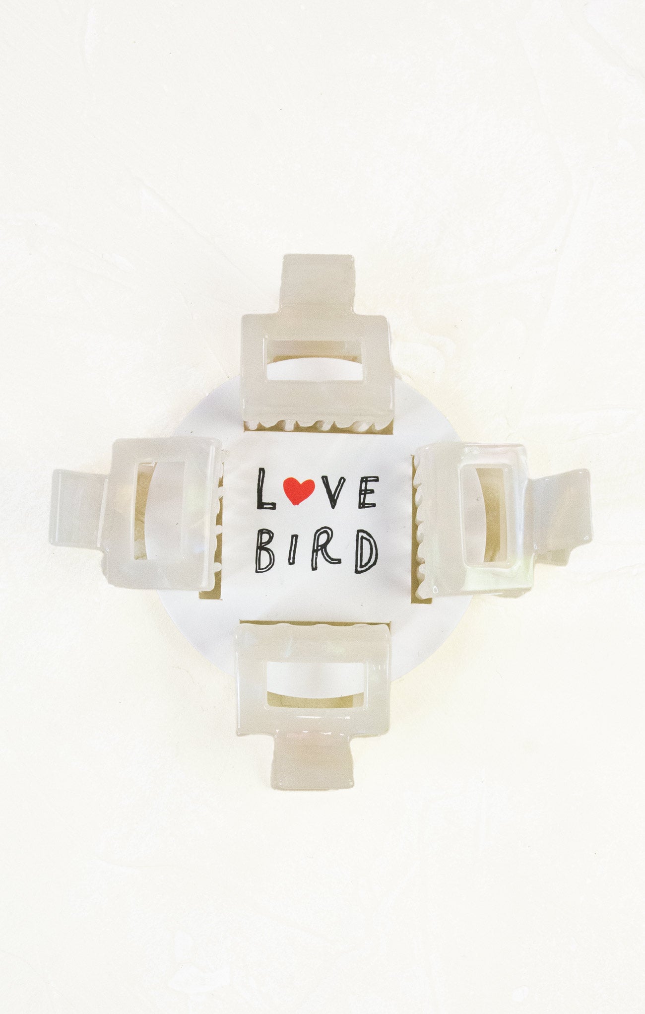 Decorative clip with 'Love Bird' text and heart symbol on a white background
