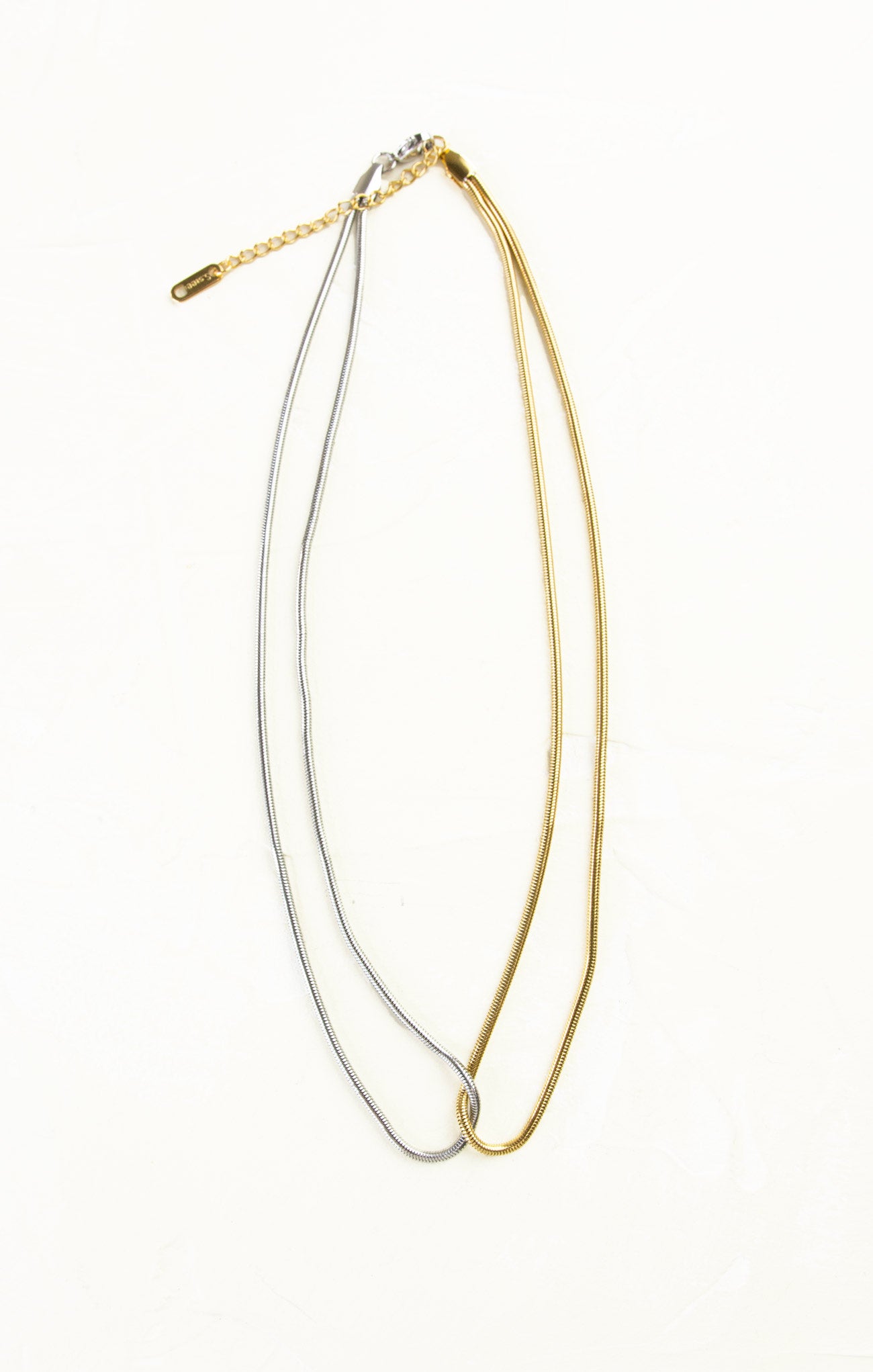 Gold and silver necklaces on a white background