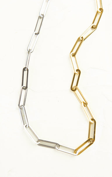 Two necklaces, one gold and one silver, on a white background