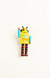 Toy robot with a yellow body and red legs on a white background