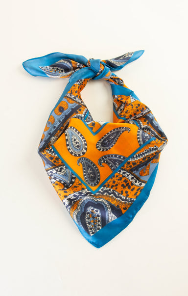 Paisley patterned bandana with orange and blue colors on a white background