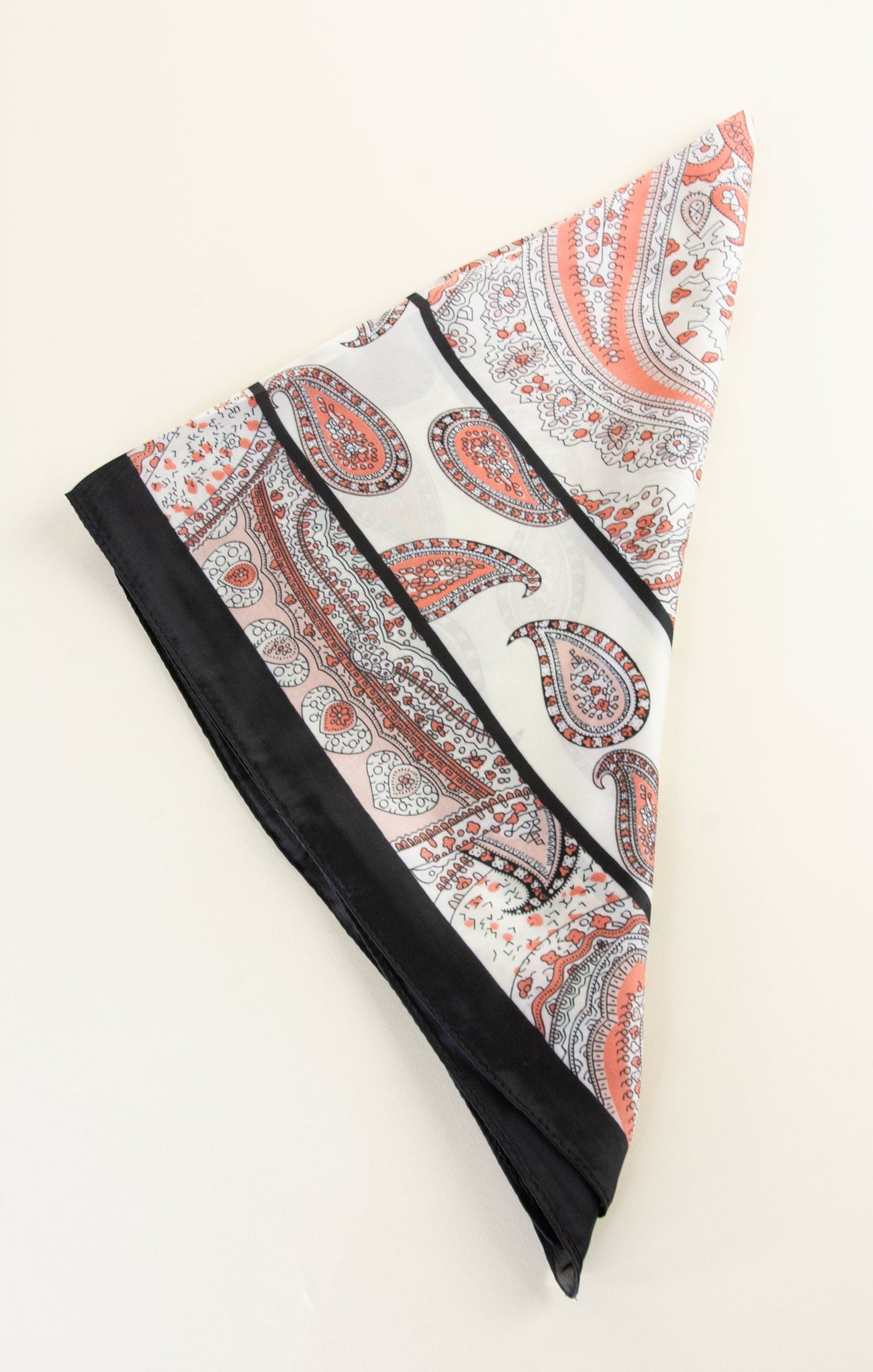 Paisley patterned headband with black trim on a white background