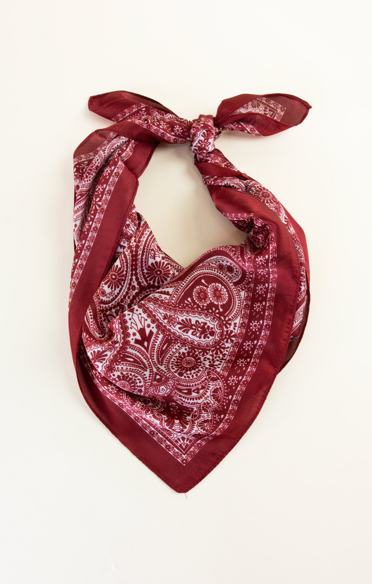 Red paisley patterned bandana on a white background