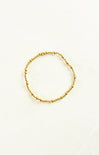 Gold beaded bracelet on a white background