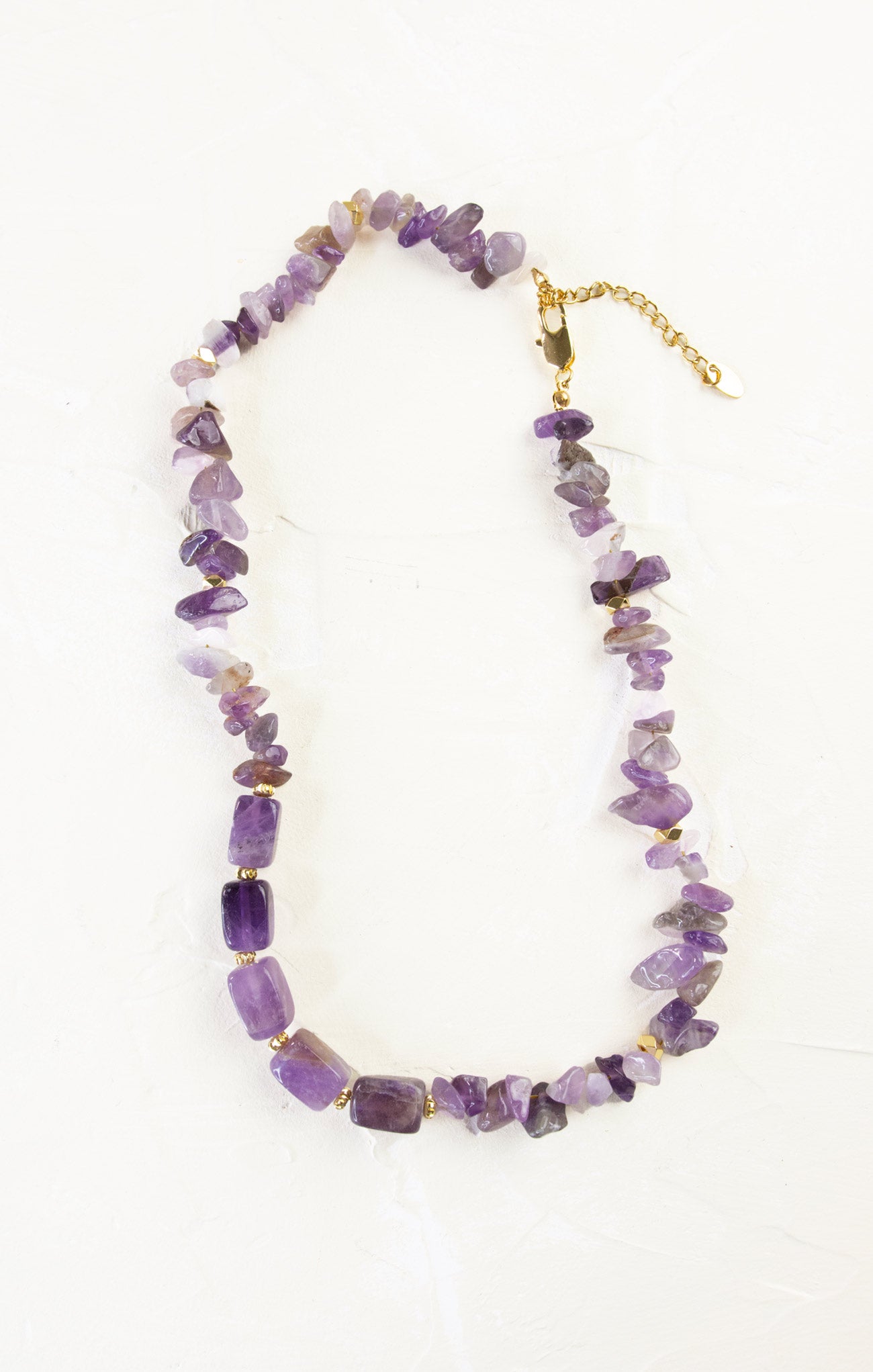 Necklace with purple beads on a white background