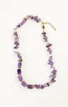 Necklace with purple beads on a white background