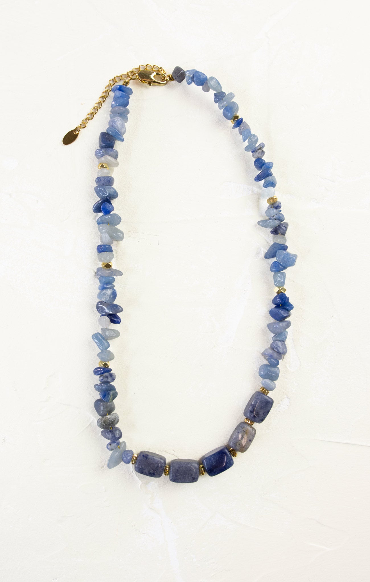 Blue beaded necklace with a gold clasp on a white background