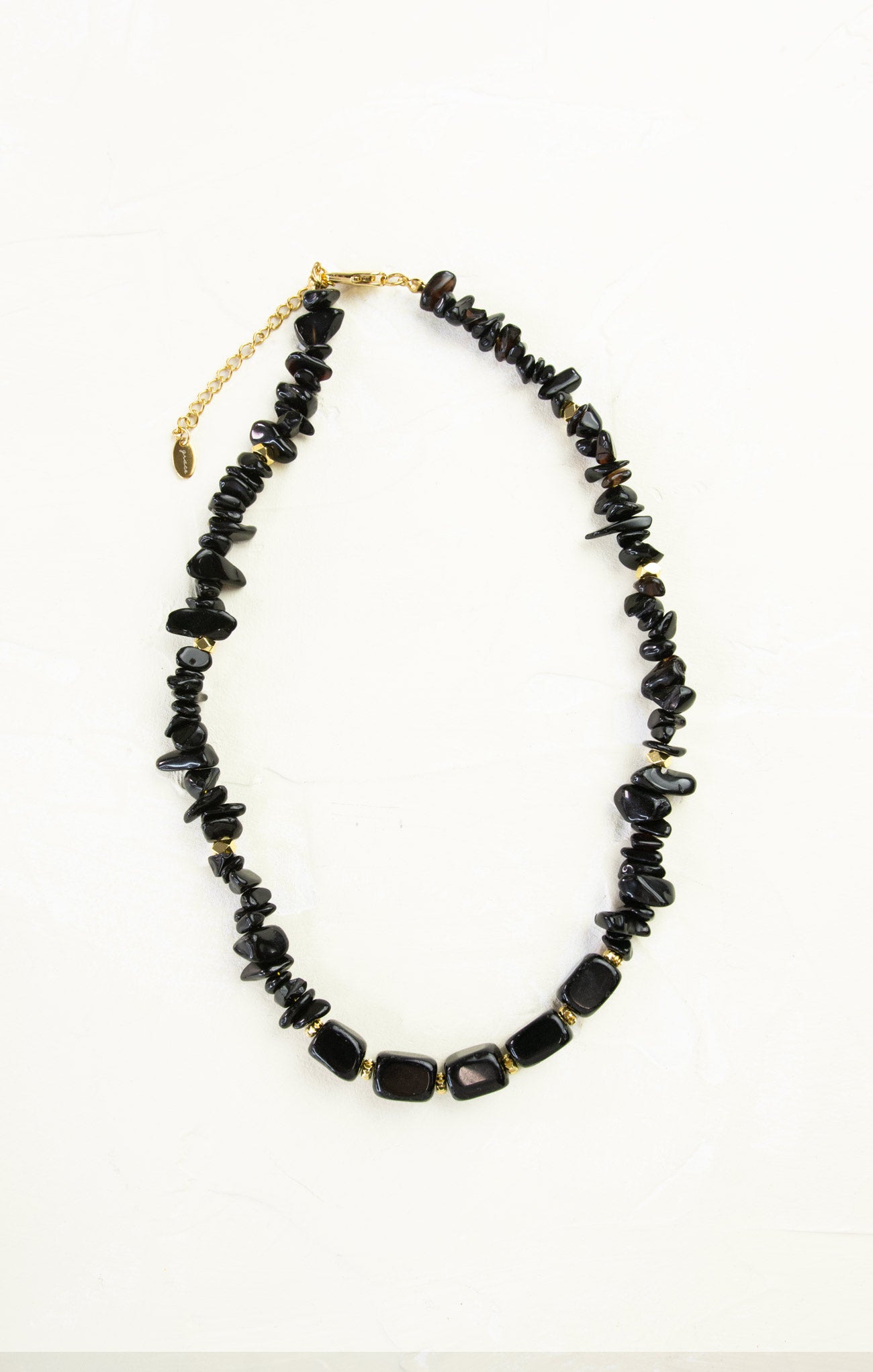 Black beaded necklace on a white background