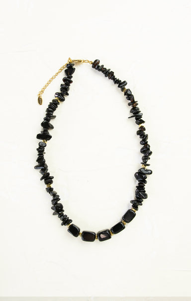 Black beaded necklace on a white background
