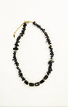 Black beaded necklace on a white background