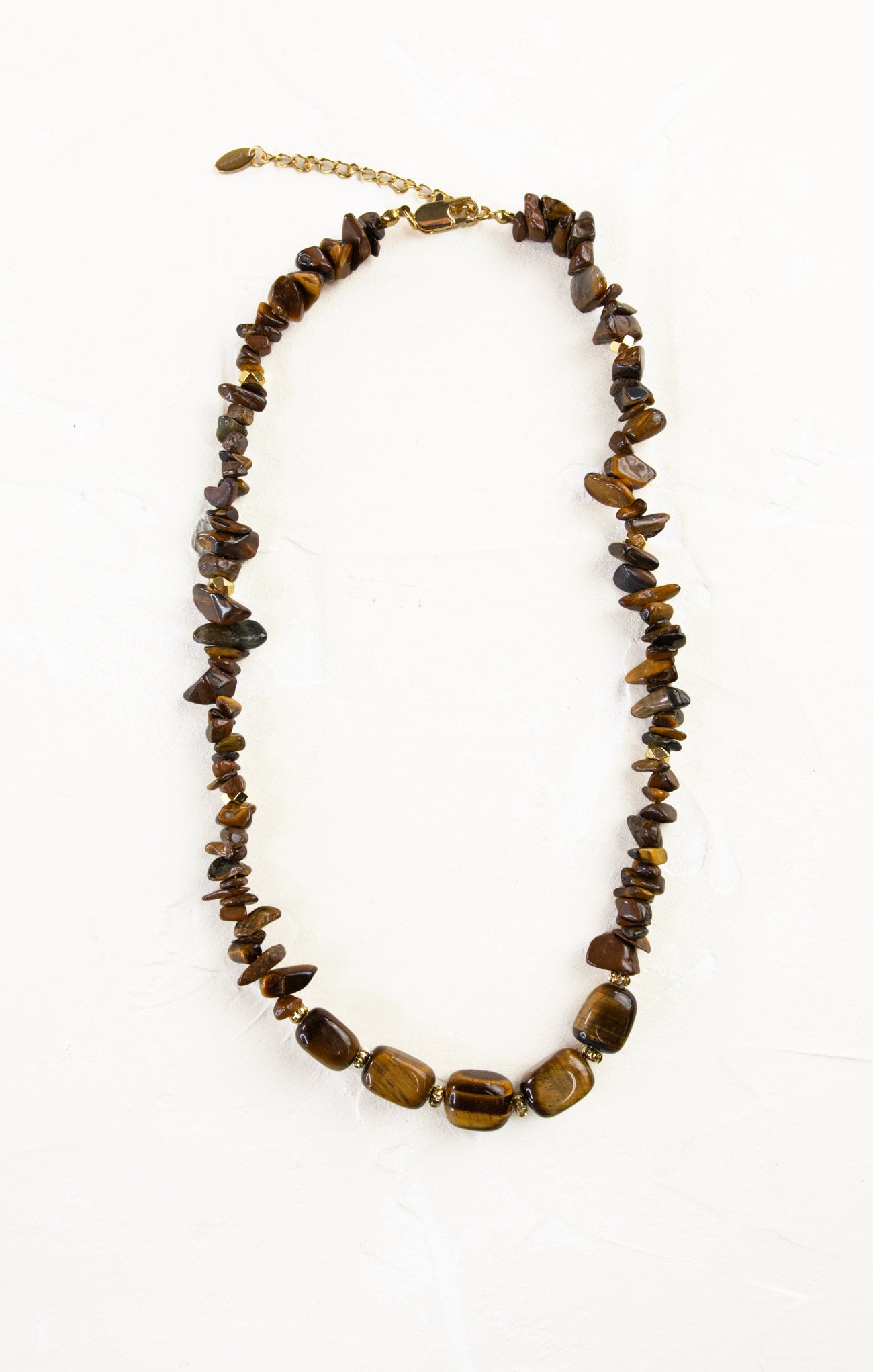 Necklace with brown beaded stones on a white background