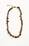 Necklace with brown beaded stones on a white background