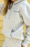 Gray hoodie with 'nantic' branding worn by a person against a yellow wall.