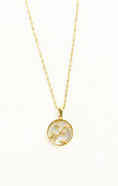 Gold necklace with a circular pendant featuring star designs on a white background