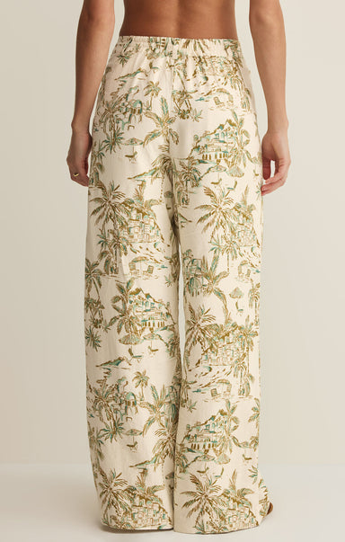 Tropical patterned pants worn by a person on a plain background
