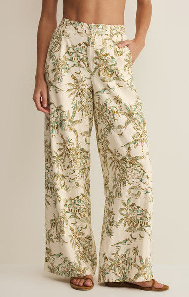 Tropical patterned pants worn by a person on a plain background
