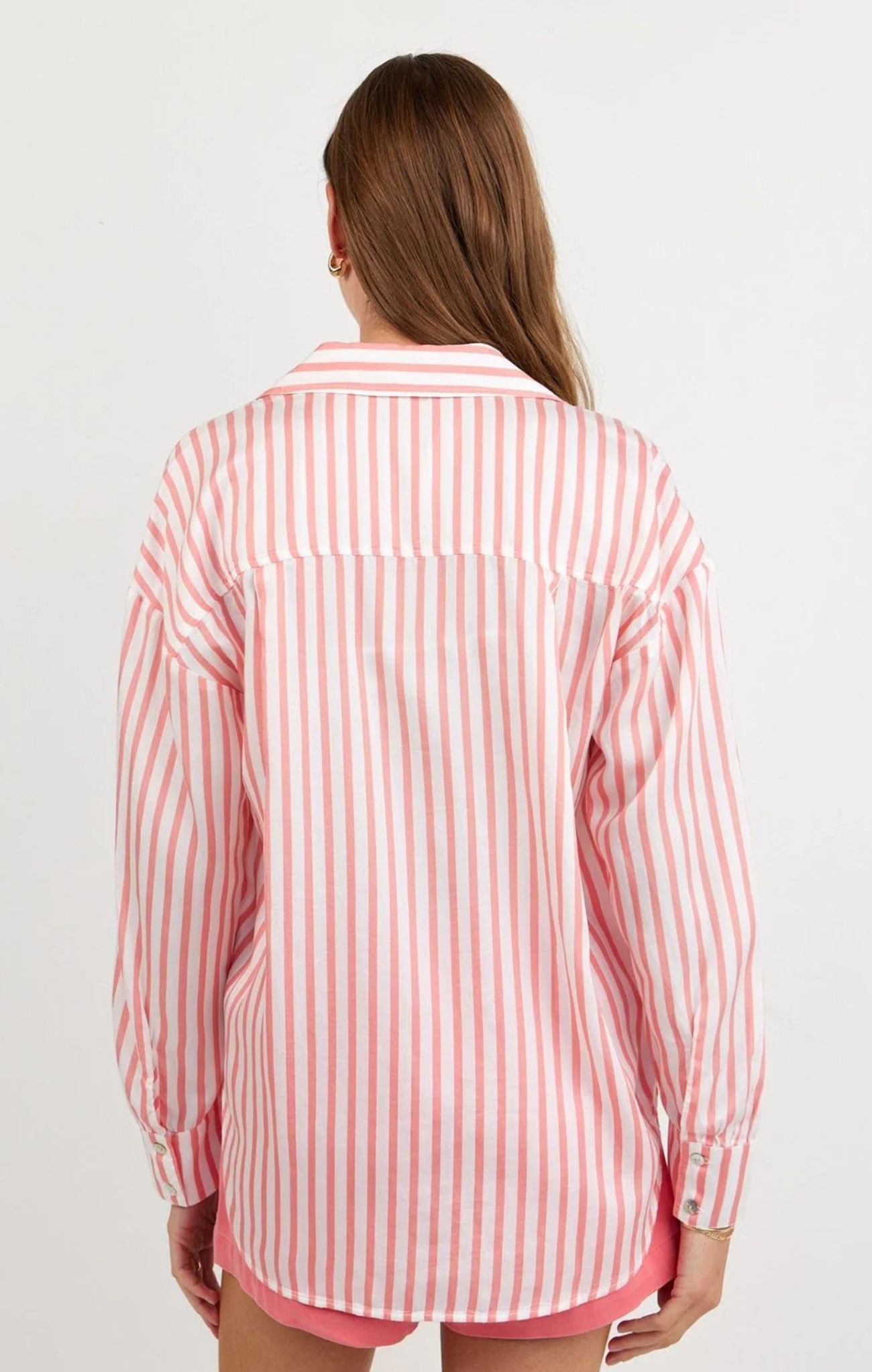 Person wearing a red and white striped shirt on a plain background
