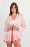 Woman wearing a pink and white striped shirt with matching shorts on a white background