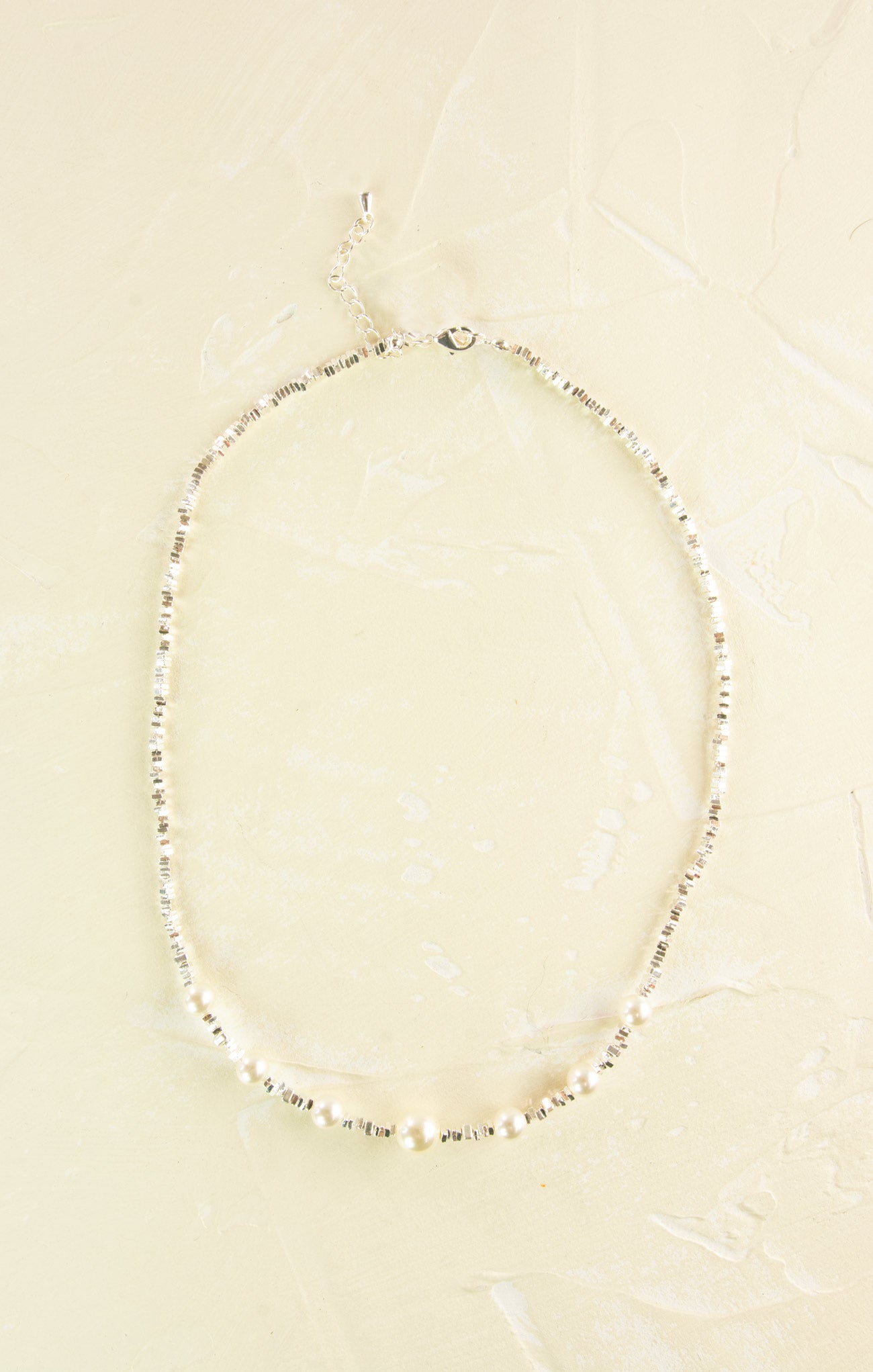 Pearl necklace on a beige background