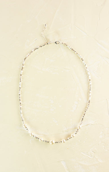 Pearl necklace on a beige background