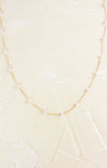 Necklace with pearls on a light beige background