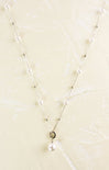Pearl necklace on a beige textured background