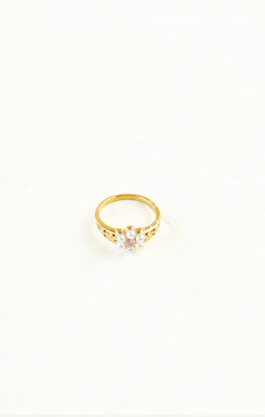 Gold ring with a pearl on a white background