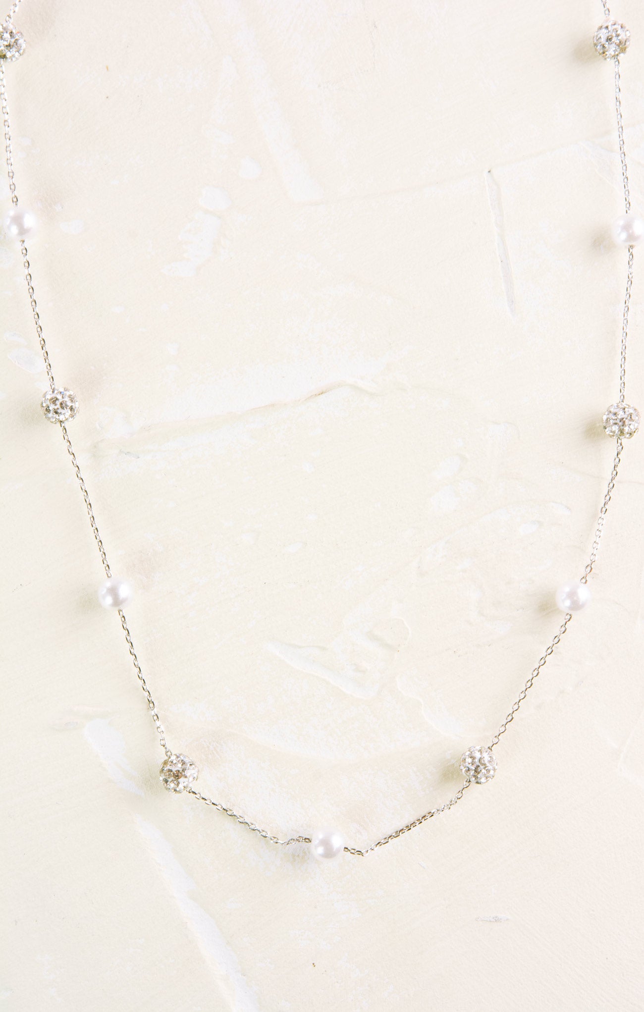 Pearl necklace on a light beige background