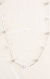 Pearl necklace on a light beige background