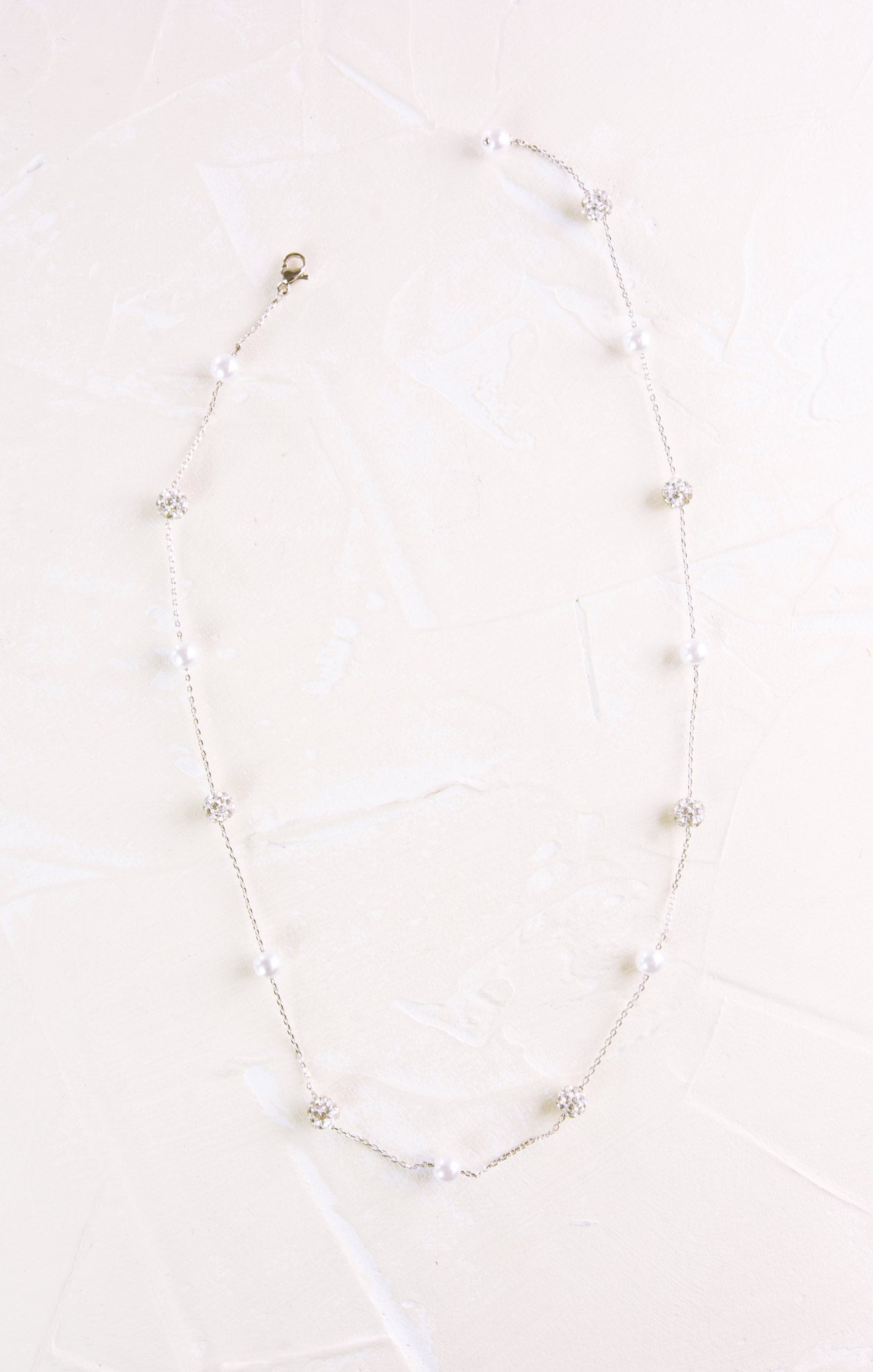 Necklace with small pearls on a white background