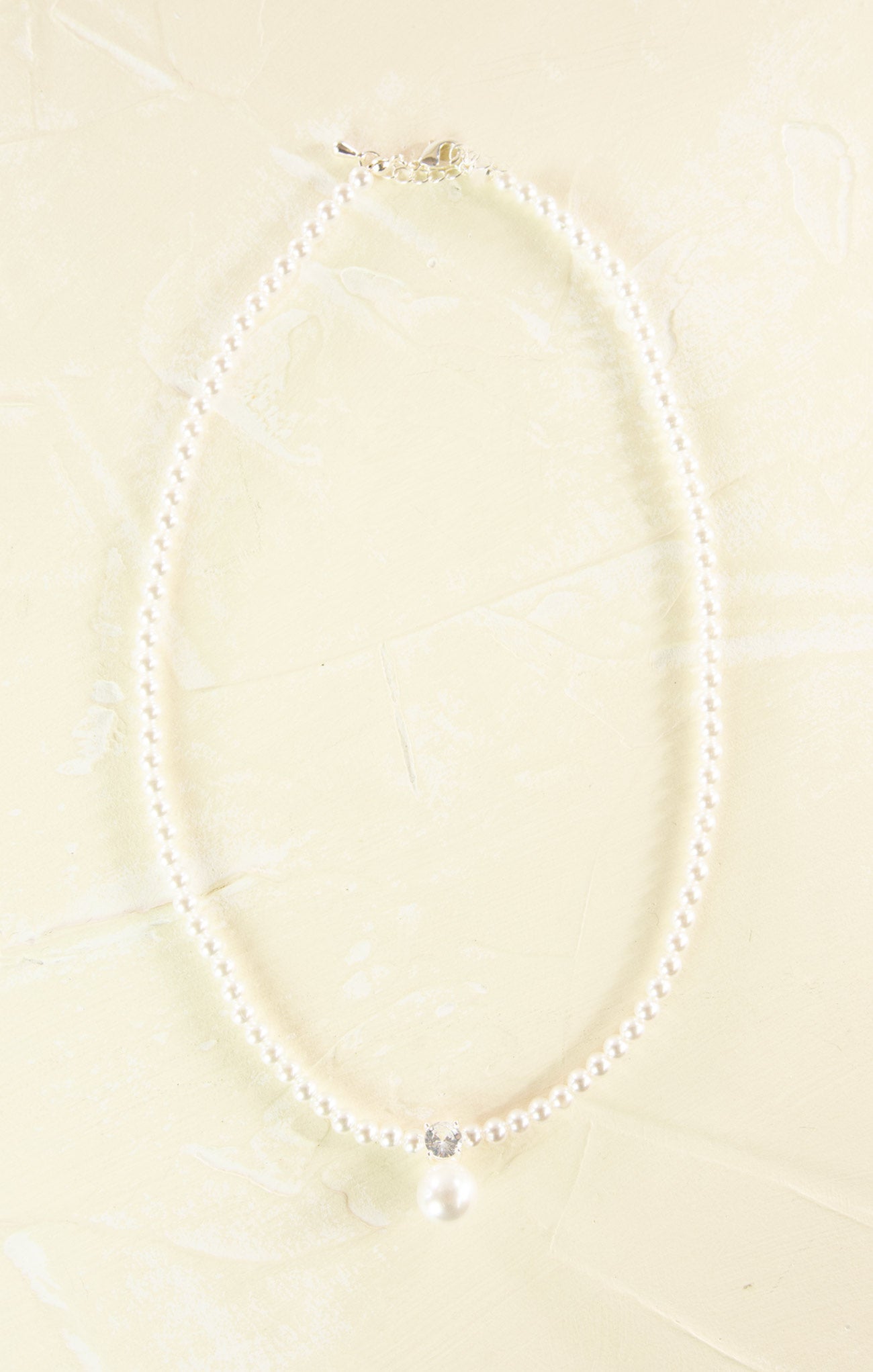 Pearl necklace on a beige background