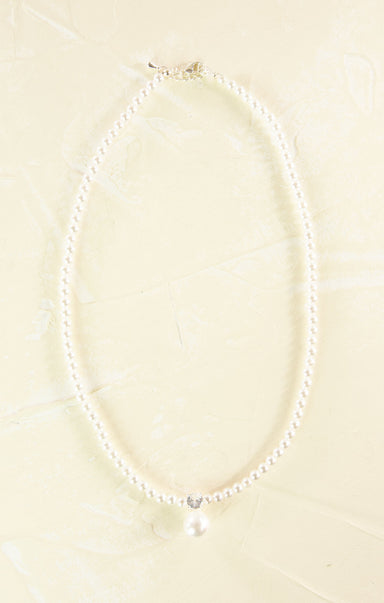 Pearl necklace on a beige background