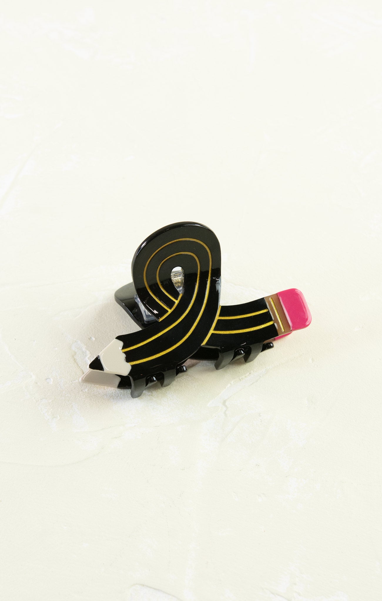 Black and gold ribbon with pink end on a white background