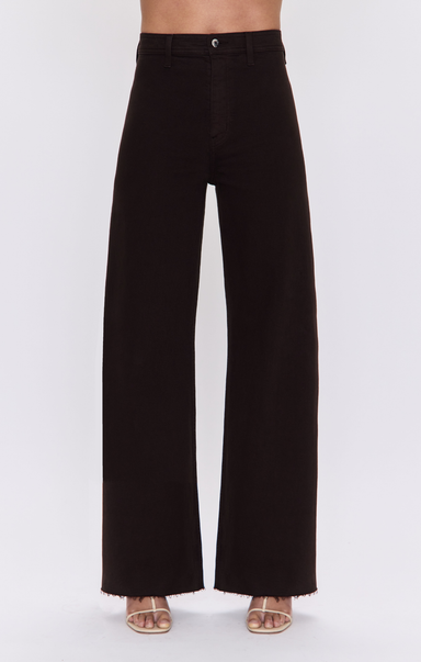 Black wide-leg cropped pants with a frayed hem, shown on a model from the waist down wearing beige sandals against a light gray background.