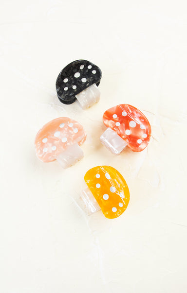 Set of colorful mushroom-shaped earrings on a white background