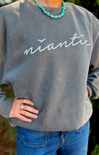 Person wearing a gray sweatshirt with 'niantic' text, standing outdoors.